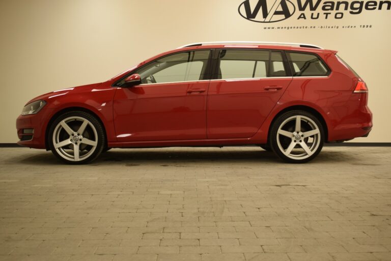 A red station wagon car is parked in a showroom with a sign that reads "Wangen Auto" on the wall.