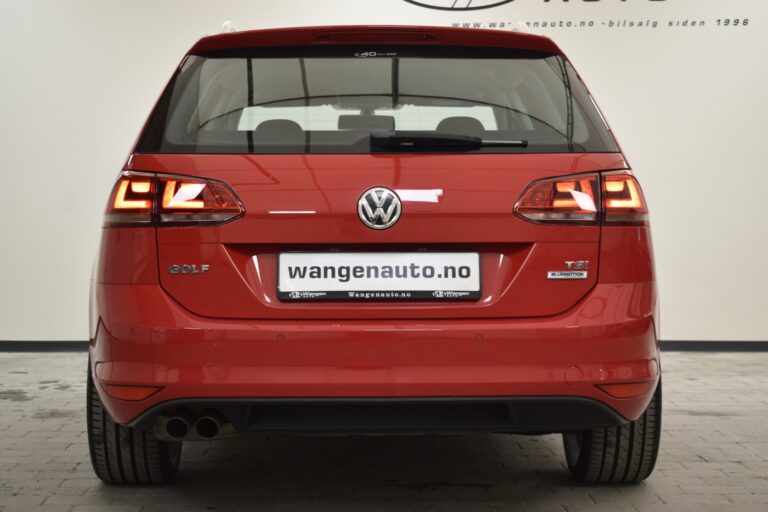 Rear view of a red Volkswagen Golf TSI parked indoors. The car's brake lights are on, and it has a license plate displaying the URL "wangenauto.no".