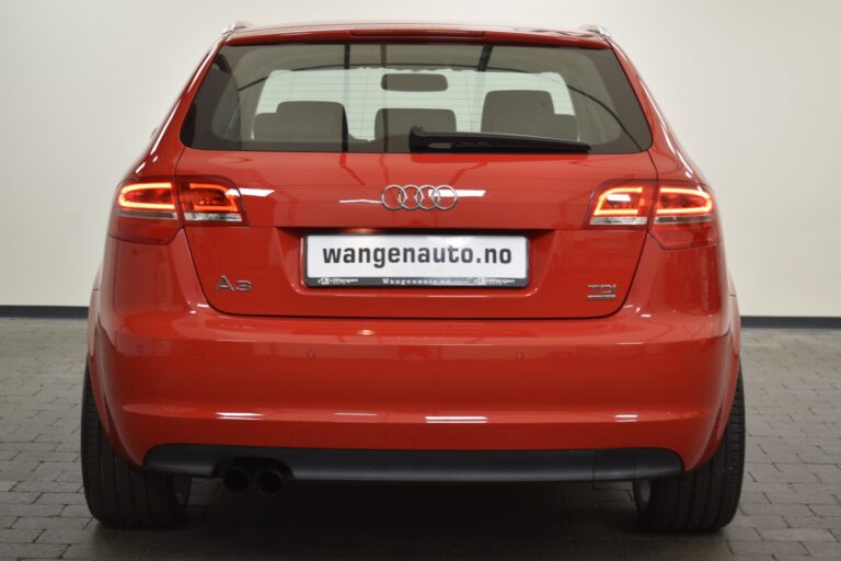 Red Audi A3 TDI viewed from the rear with brake lights on, displaying a license plate reading "wangenauto.no" in a garage setting.