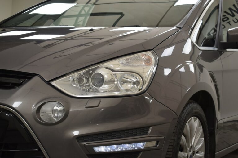 Close-up of a gray car's front side. Shows a headlight, circular fog light, and LED strip.