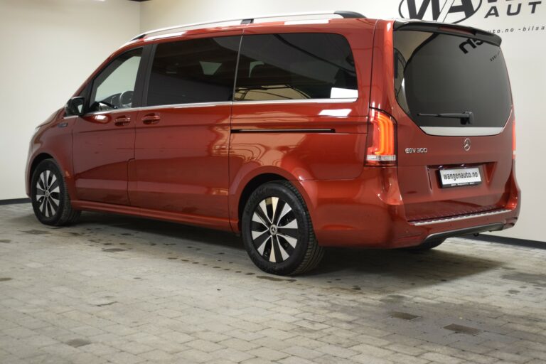 A red Mercedes-Benz van parked indoors on a tiled floor, viewed from the rear passenger side.