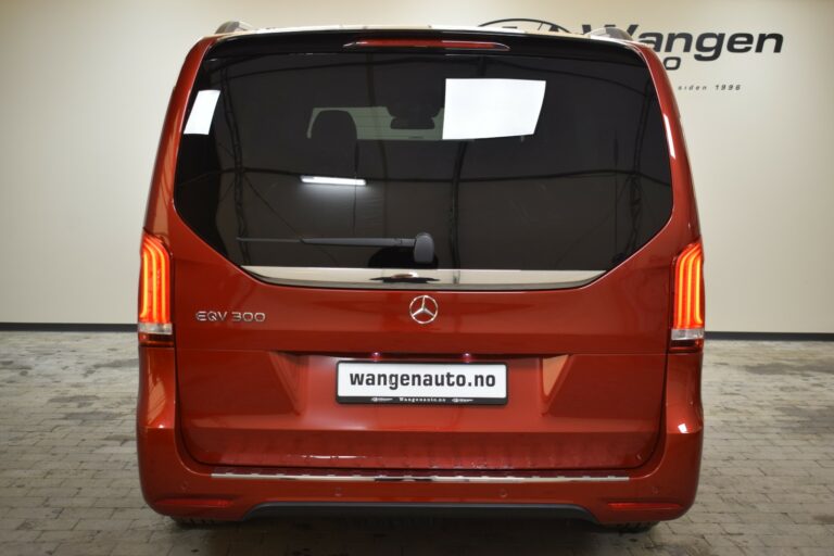 Rear view of a red Mercedes EQV 300 parked indoors, featuring Wangen Auto dealership branding.