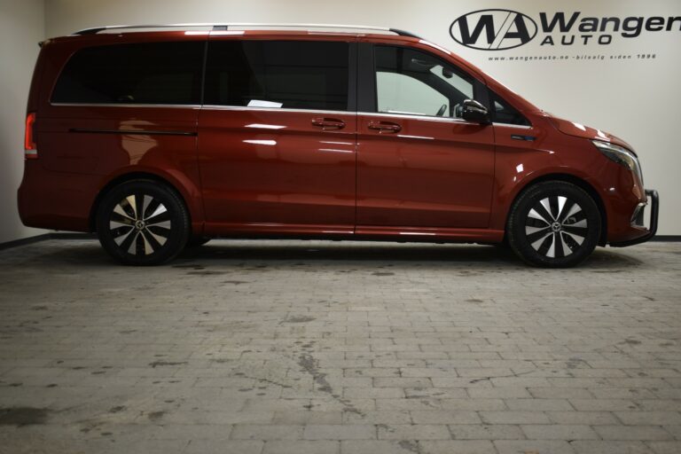 Side view of a brown van parked indoors with "Wanger Auto" signage on the wall.