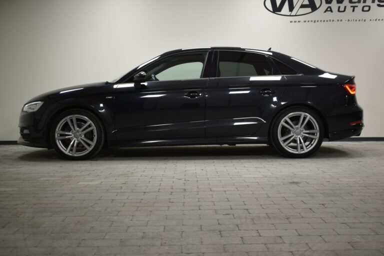 Side view of a black sedan parked indoors on a light-colored tiled floor.