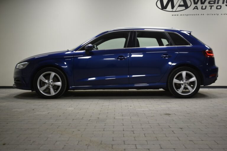 A blue hatchback car is parked indoors on a tiled floor.