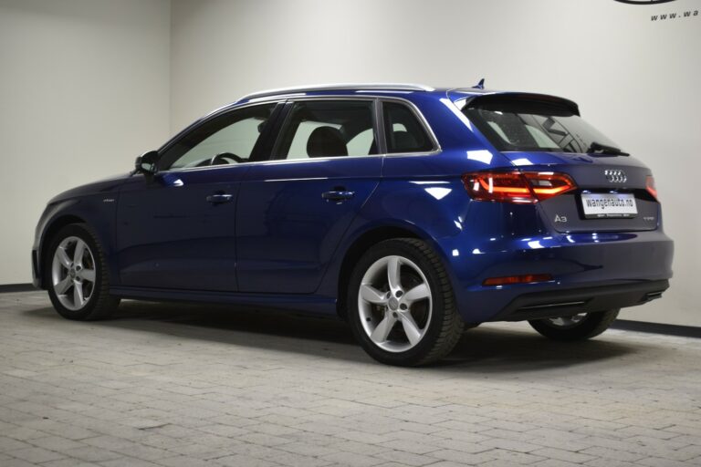 A blue Audi A3 hatchback parked indoors, viewed from the rear side.