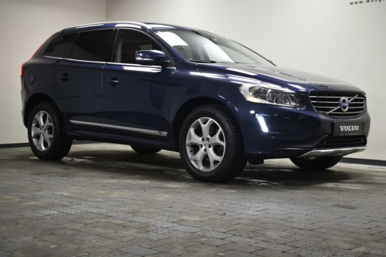 Dark blue SUV parked indoors on a stone-tiled floor.