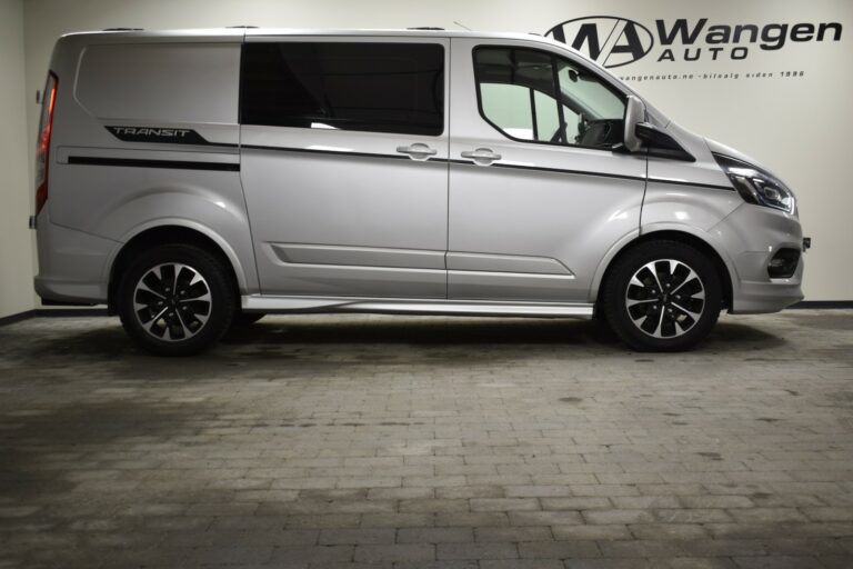 Side view of a silver Ford Transit van parked indoors next to a wall with the "Wangen Auto" logo.