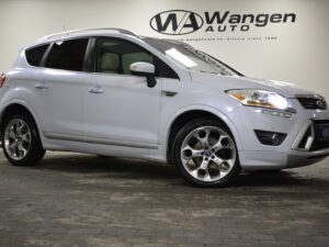 Silver SUV parked in a showroom with logo "Wangen Auto" on the wall.