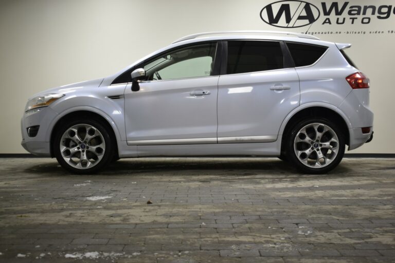 Side view of a silver SUV parked indoors on a tiled floor.