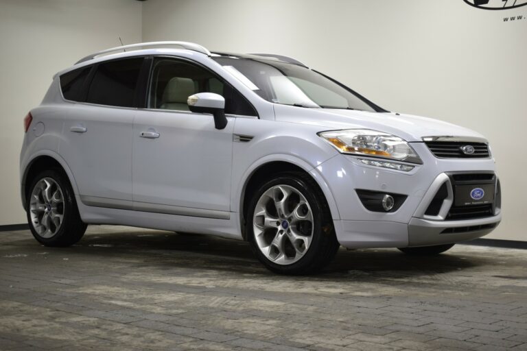 Silver Ford SUV parked on a paved surface, shown at an angle from the front passenger side.